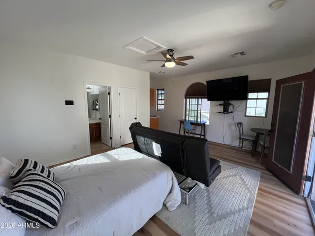 a bedroom with a bed and wooden floor