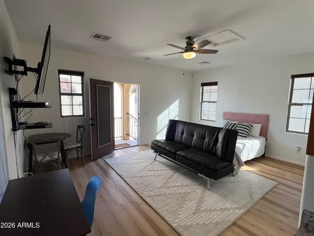 a living room with furniture and a chandelier