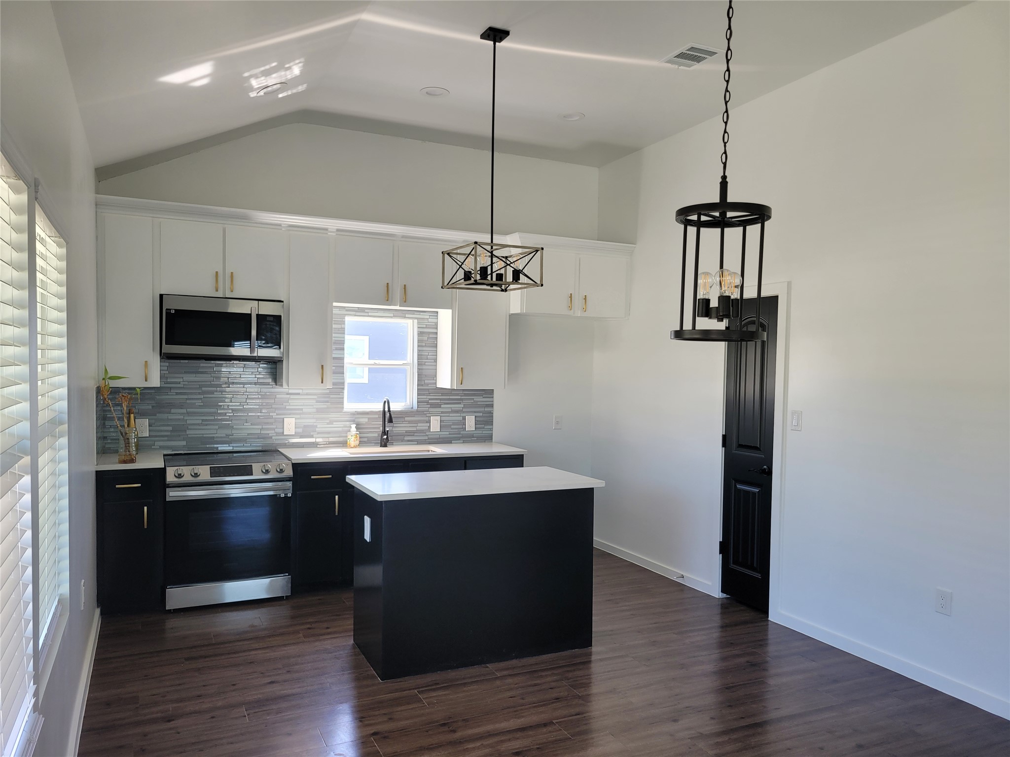 422 County Road 422 Road Stockdale, TX 78160 - Photo 7 of 37 An inviting kitchen with vaulted ceilings, a central island, and modern pendant lighting.