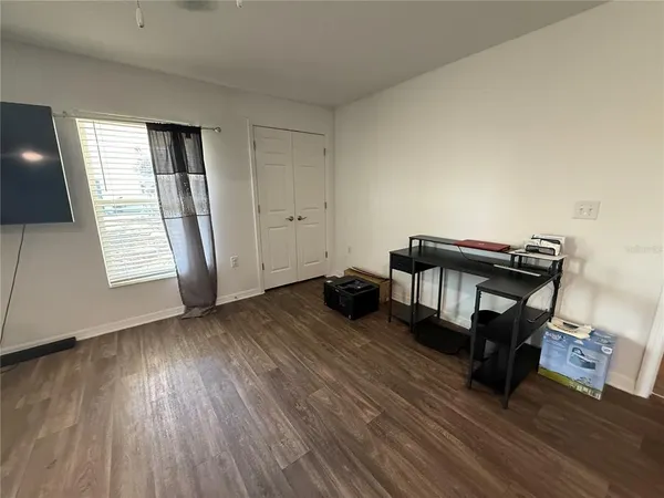 a view of a livingroom with wooden floor and a window