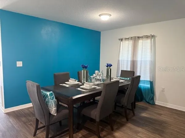 a view of a dining room with furniture and wooden floor