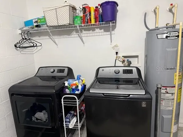 a utility room with dryer washer and other items