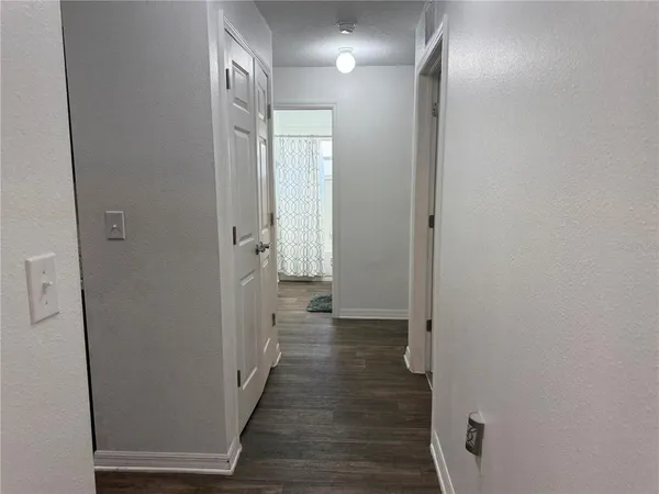 a view of a hallway with wooden floor