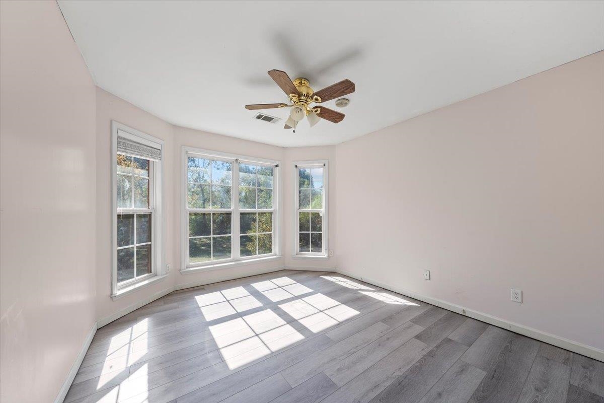 10941 Lubov Road Arlington, TN 38002 - Photo 21 of 39 an empty room with wooden floor and windows