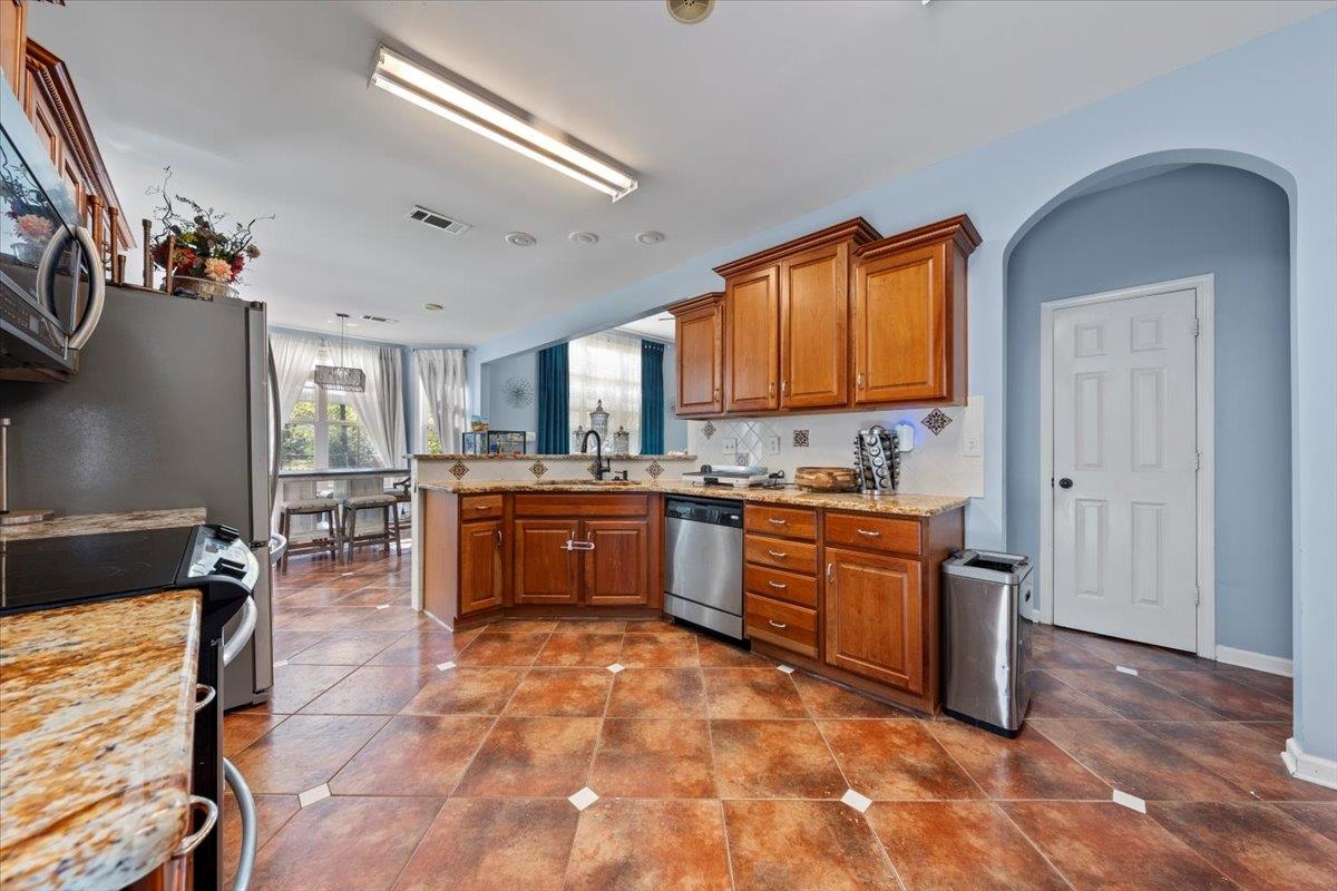 10941 Lubov Road Arlington, TN 38002 - Photo 9 of 39 a kitchen with sink a stove and cabinets