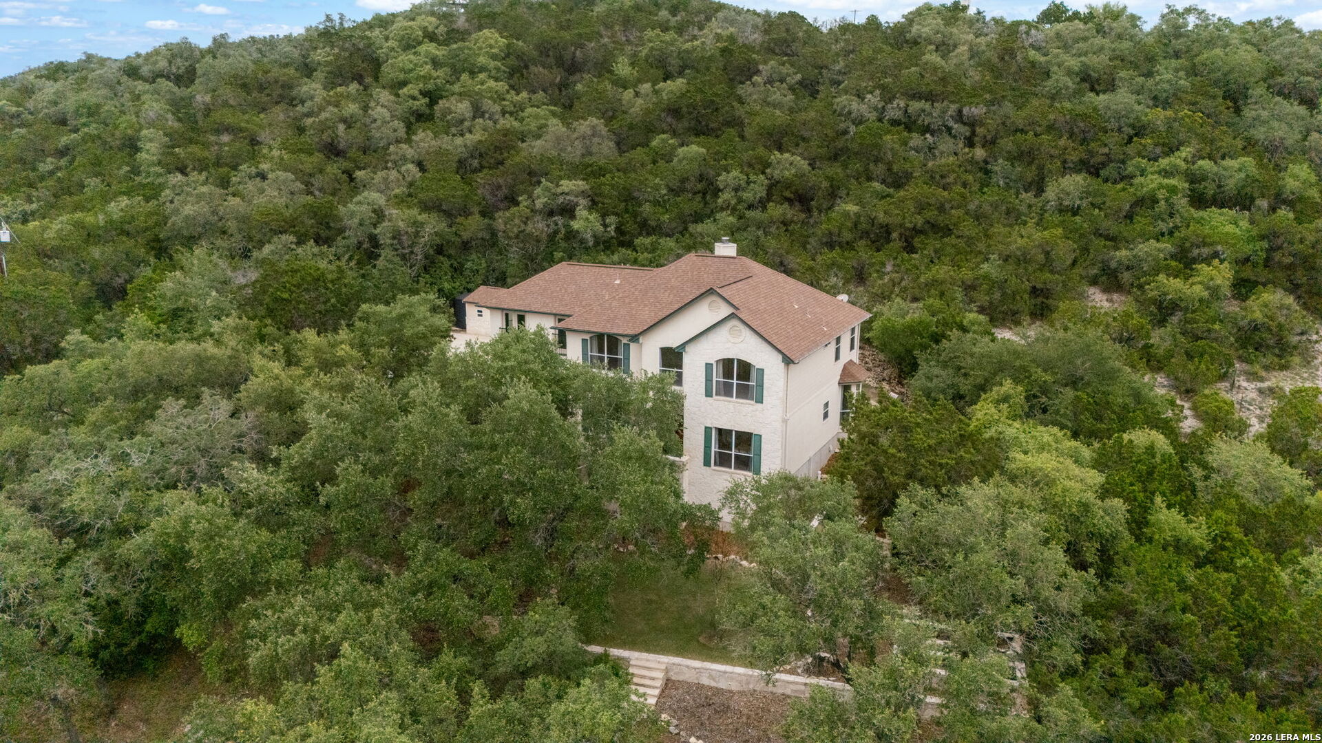 17431 Helotes Spring Road Helotes, TX 78023 - Photo 45 of 50 an aerial view of a house with yard and trees in the background