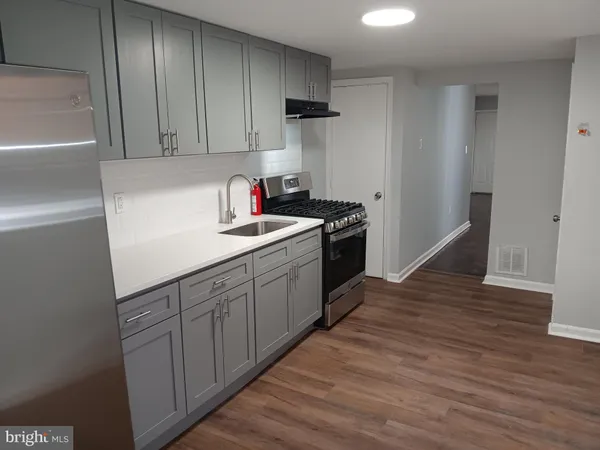 a kitchen with a sink cabinets and stainless steel appliances