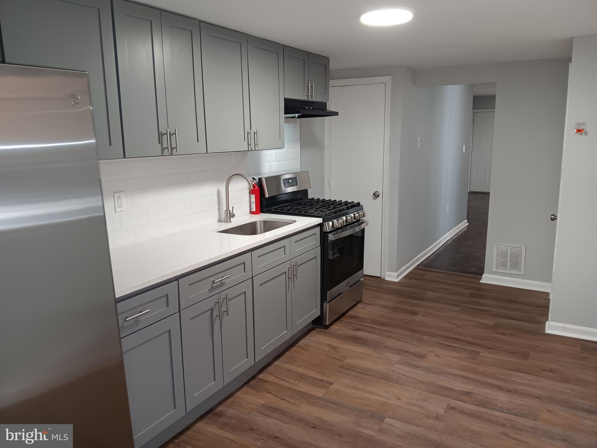 a kitchen with a sink cabinets and stainless steel appliances