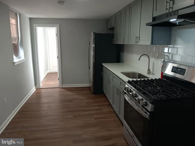 a kitchen with granite countertop a stove and a refrigerator