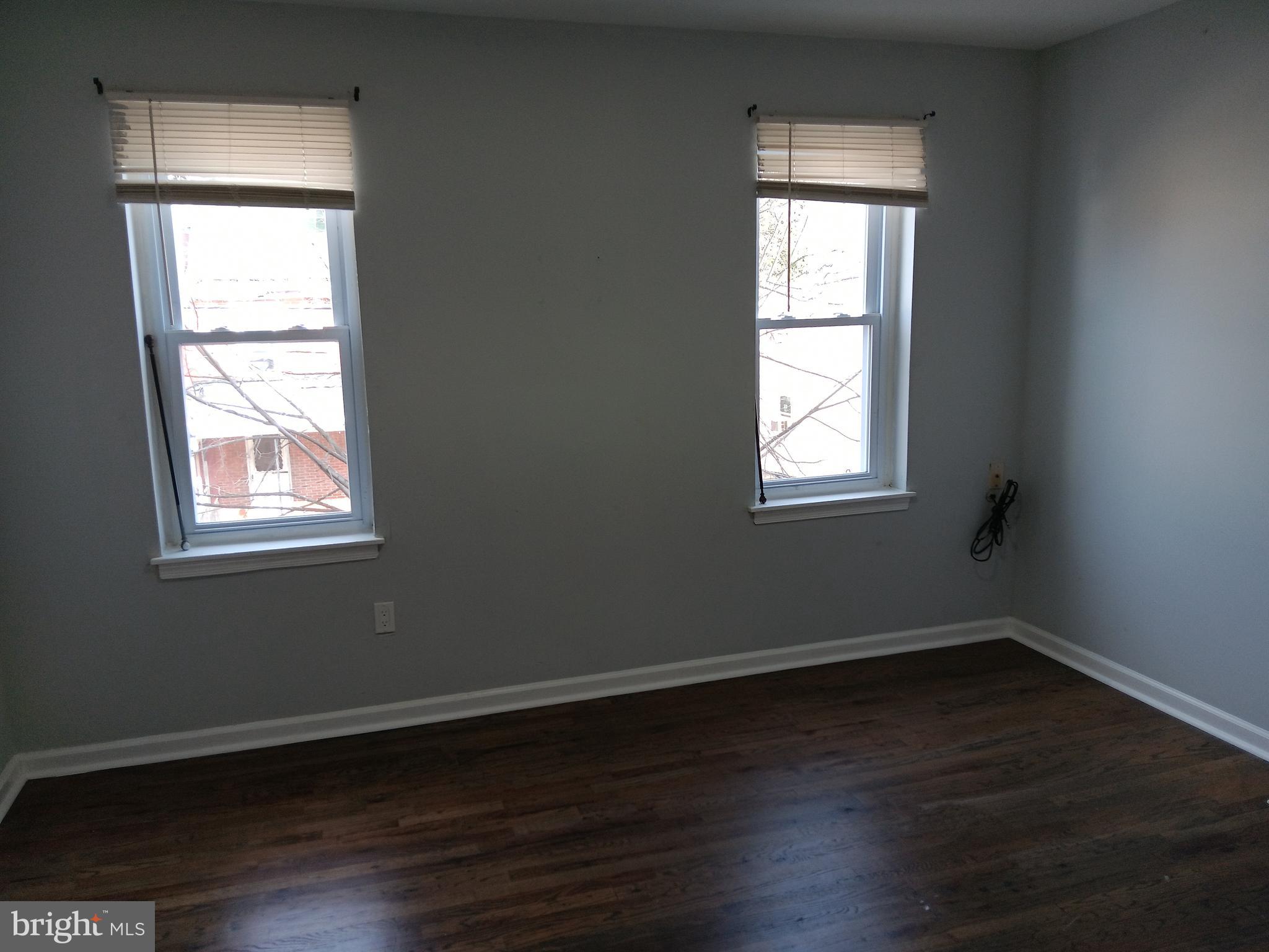 1020 Potter Street Chester, PA 19013 - Photo 4 of 16 an empty room with wooden closet and windows