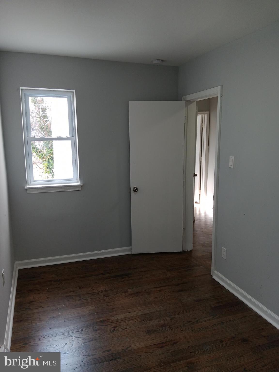 1020 Potter Street Chester, PA 19013 - Photo 6 of 16 an empty room with wooden floor and windows