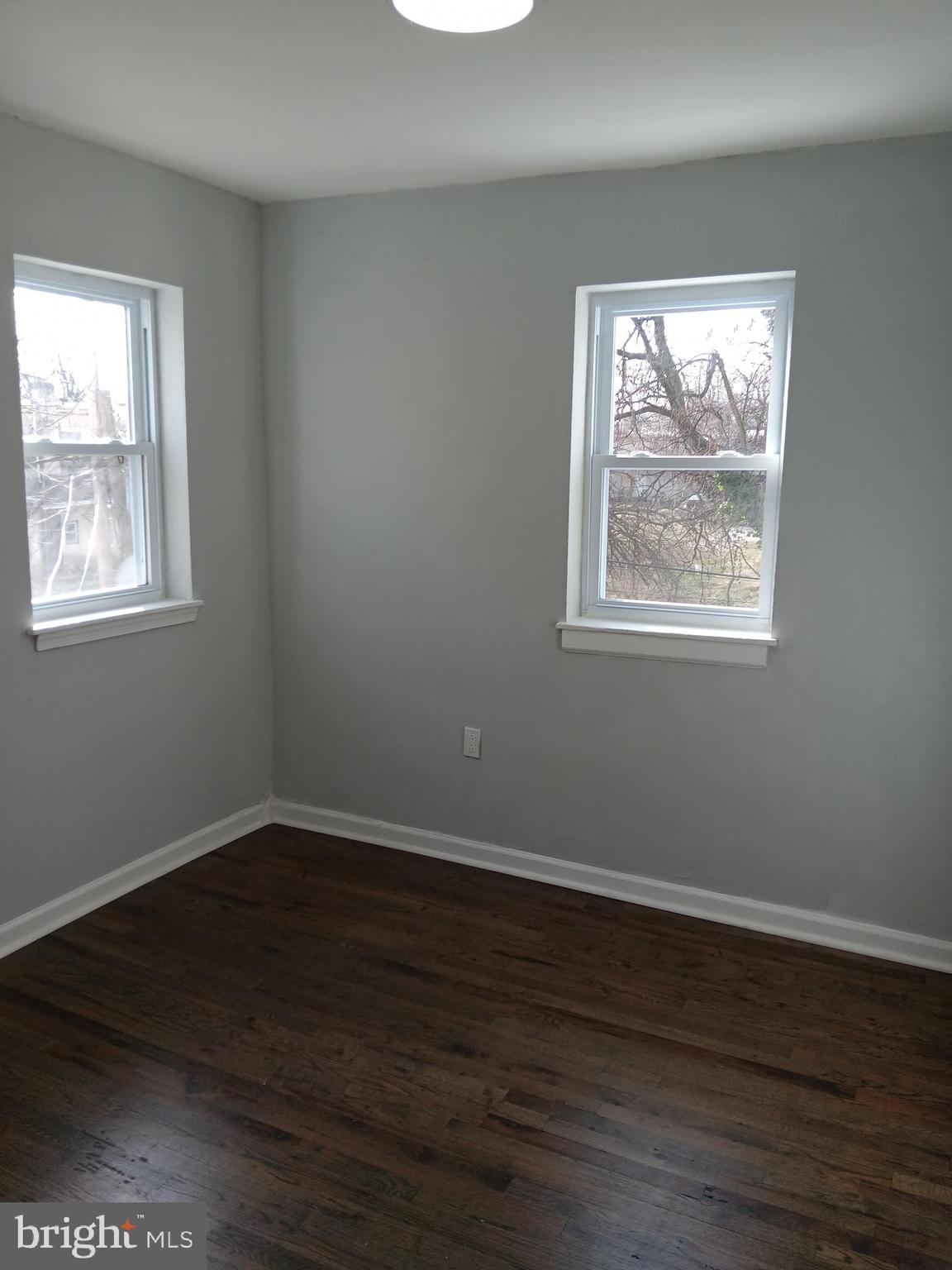 1020 Potter Street Chester, PA 19013 - Photo 7 of 16 an empty room with wooden floor and windows
