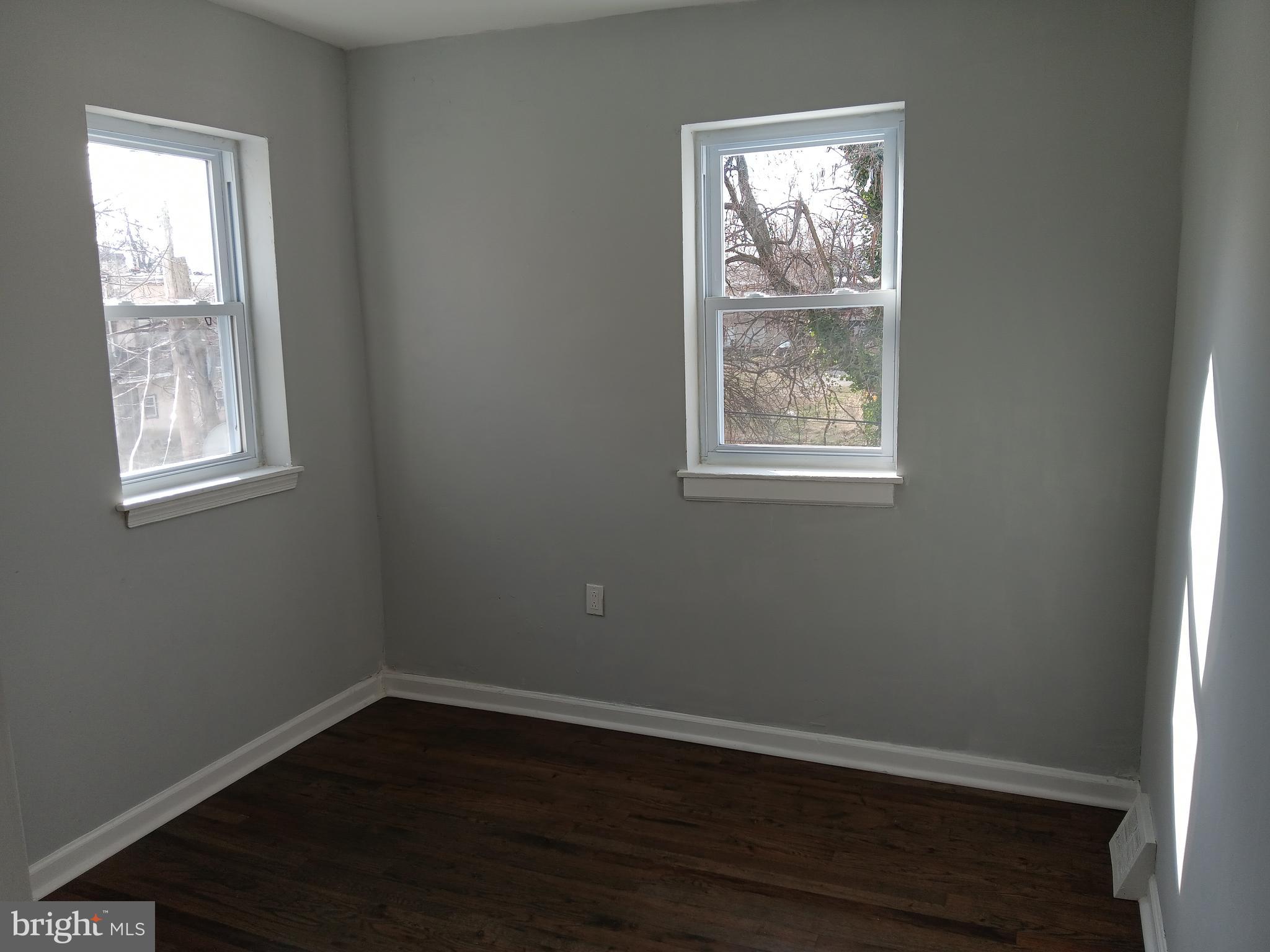 1020 Potter Street Chester, PA 19013 - Photo 8 of 16 a view of an empty room with wooden floor and a window
