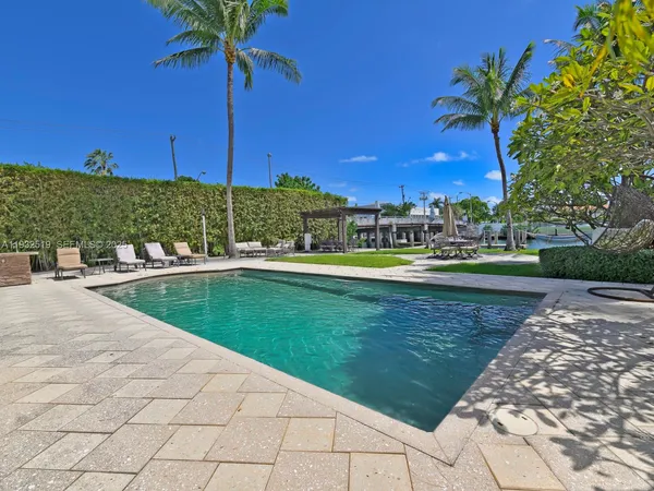 a view of a swimming pool and trees in the background