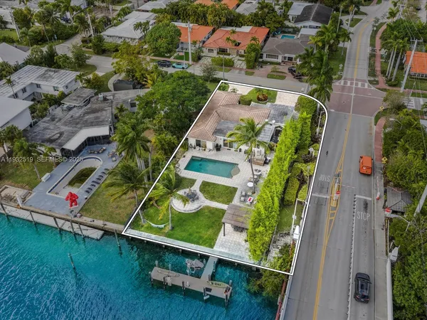 an aerial view of residential house with outdoor space and swimming pool