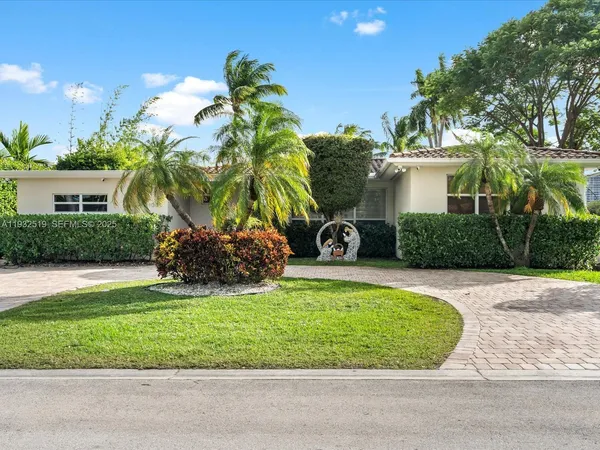 a view of a house with a yard and a garden