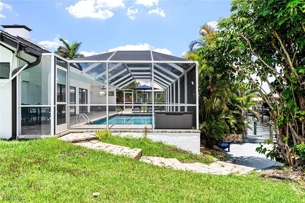 a view of a house with backyard and sitting area