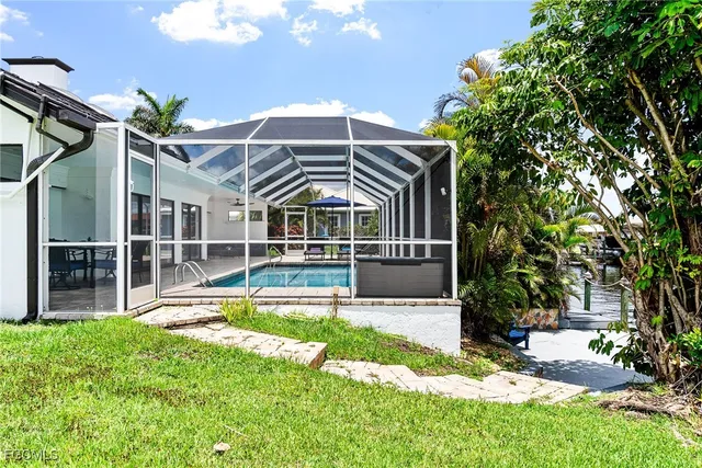 a view of a house with backyard and sitting area