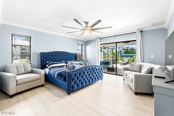 a bedroom with a large bed couch and a large window