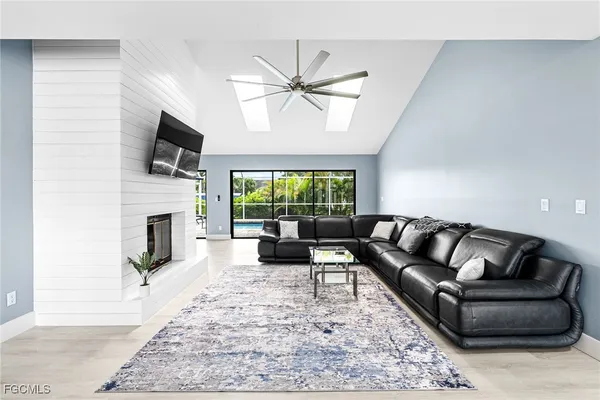 a living room with furniture a fireplace and a flat screen tv