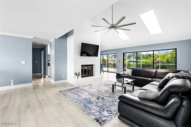 a living room with furniture a fireplace and a flat screen tv