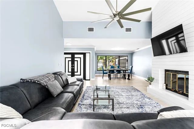 a living room with furniture large window and a fireplace