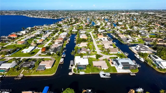 an aerial view of a swimming pool a patio and outdoor seating
