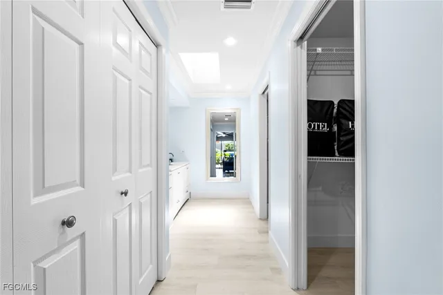 a view of a hallway with white walls and stairs