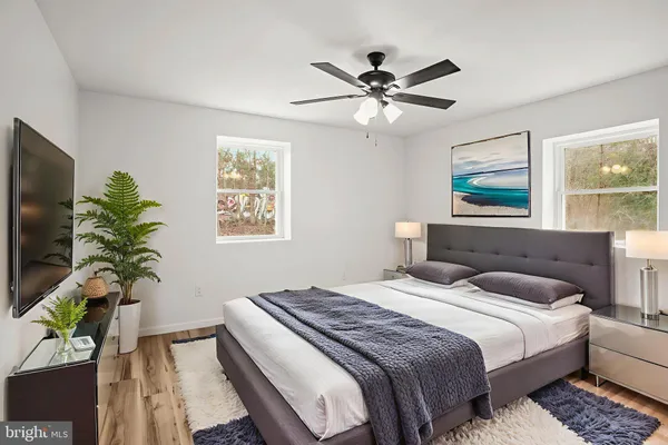 a bedroom with a large bed and a potted plant