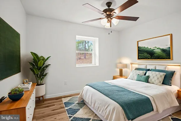 a bedroom with a bed and a potted plant
