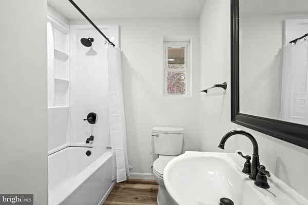 a bathroom with a sink a bathtub and a shower