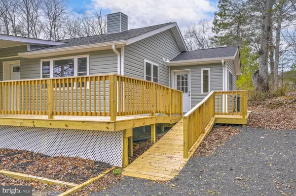 a view of a house with a wooden deck