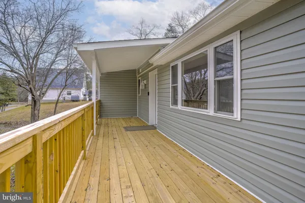 a view of wooden balcony with a bench