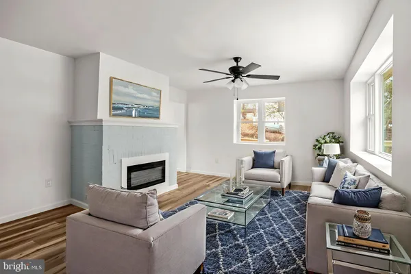 a living room with furniture a window and a fireplace