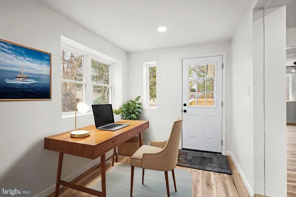 a view of a workspace with furniture and a window