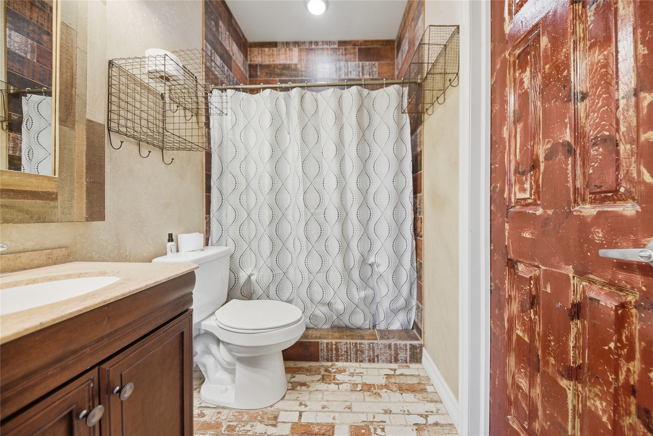 25062 Highway 159 East Hempstead, TX 77445 - Photo 33 of 49 a bathroom with a sink a toilet and shower curtain
