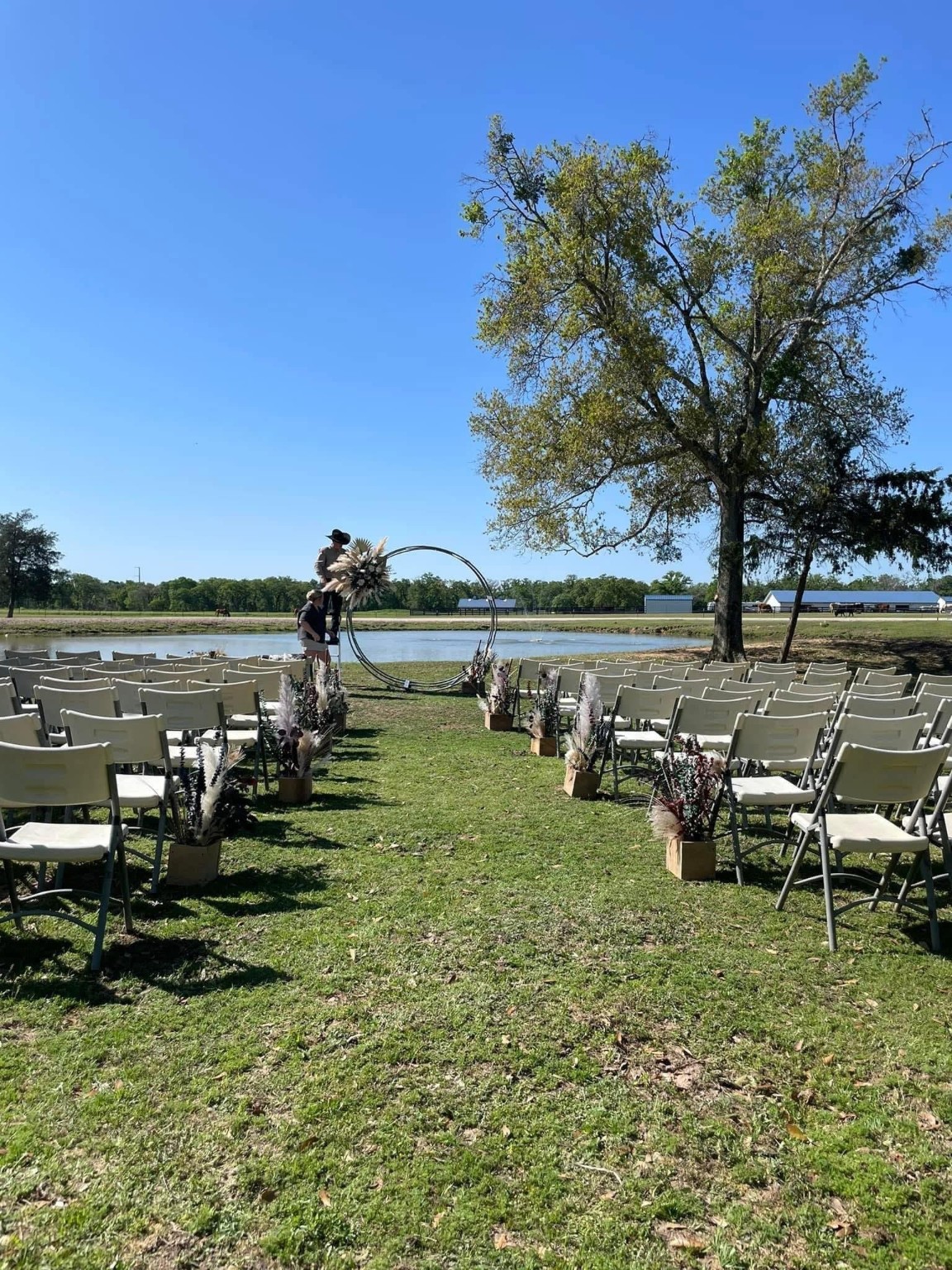 25062 Highway 159 East Hempstead, TX 77445 - Photo 43 of 49 a view of a lake with lawn chairs and large trees