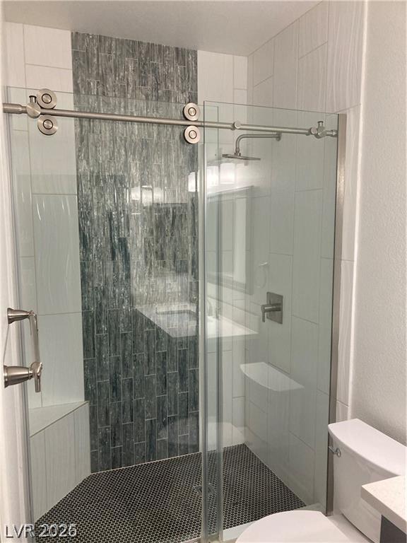 9050 West Warm Springs Road, Unit 1027 Las Vegas, NV 89148 - Photo 28 of 44 A chic, contemporary bathroom shower features sleek glass doors and varied tile work.