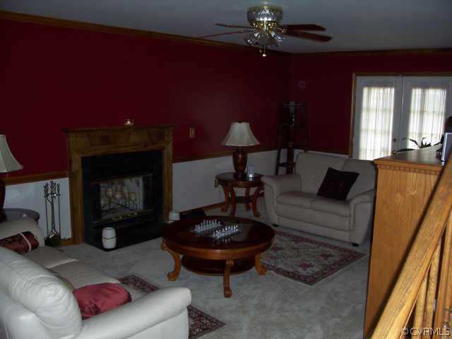 5612 Gatebridge Road Richmond, VA 23234 - Photo 3 of 9 a living room with furniture and a fireplace