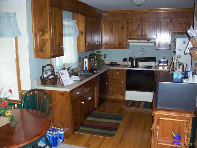 5612 Gatebridge Road Richmond, VA 23234 - Photo 4 of 9 a kitchen with stainless steel appliances granite countertop a sink stove and cabinets