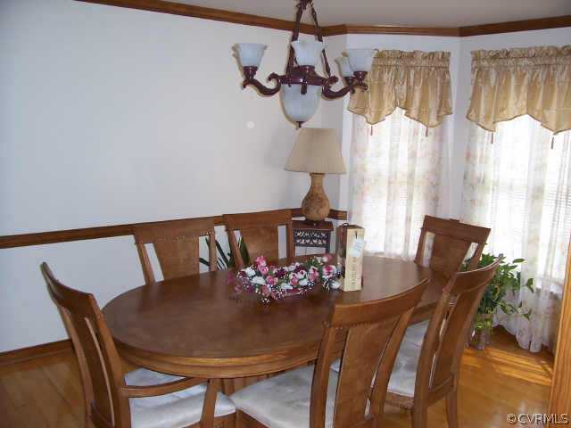 5612 Gatebridge Road Richmond, VA 23234 - Photo 5 of 9 a view of a dining room with furniture and wooden floor