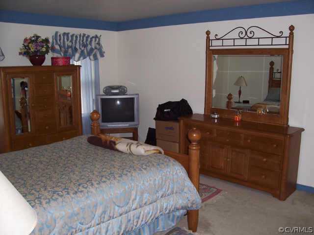 5612 Gatebridge Road Richmond, VA 23234 - Photo 6 of 9 a bedroom with a bed and a dresser