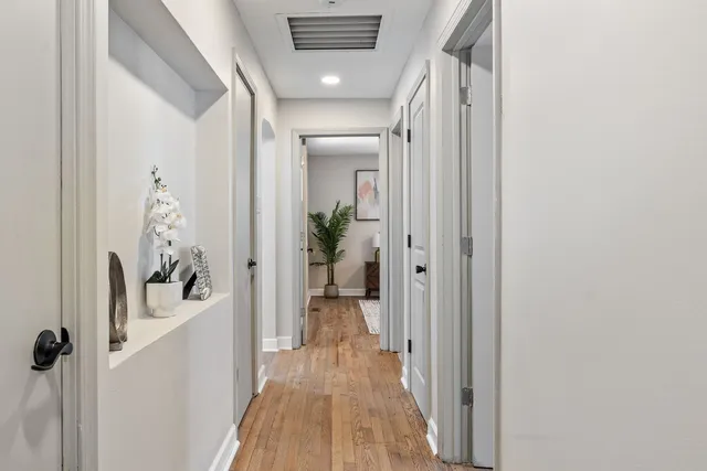 a view of a hallway with a livingroom and a hallway