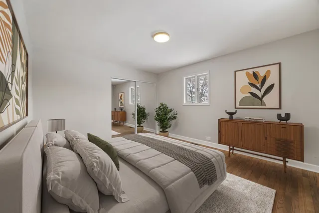 a bedroom with a bed and a painting on the wall