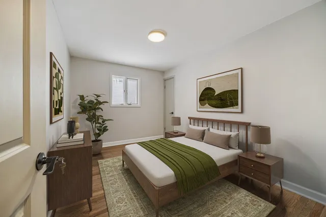 a bedroom with a bed and a potted plant