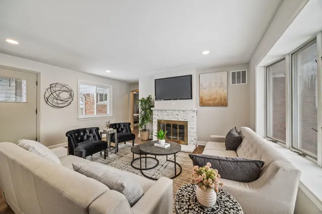 a living room with furniture and a fireplace