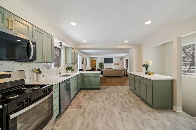 a kitchen with a sink stove top oven and microwave