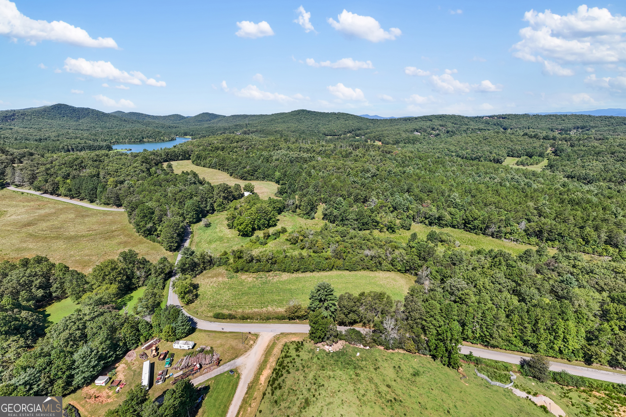 1489 Boy Scout Road Blairsville, GA 30512 - Photo 13 of 43 an aerial view of green landscape with trees houses and mountain view