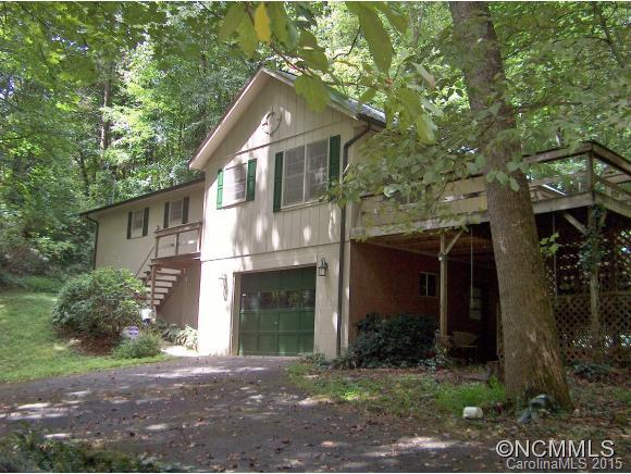 55 Holstein Farm Road Waynesville, NC 28785 - Photo 2 of 24 a front view of a house with a yard and garage