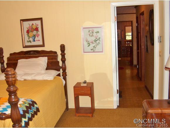 55 Holstein Farm Road Waynesville, NC 28785 - Photo 12 of 24 a bedroom with a bed and a painting on the wall